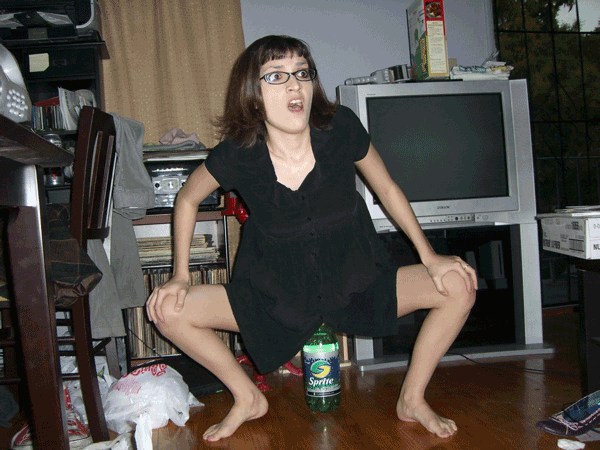 what is she doing to that sprite bottle?